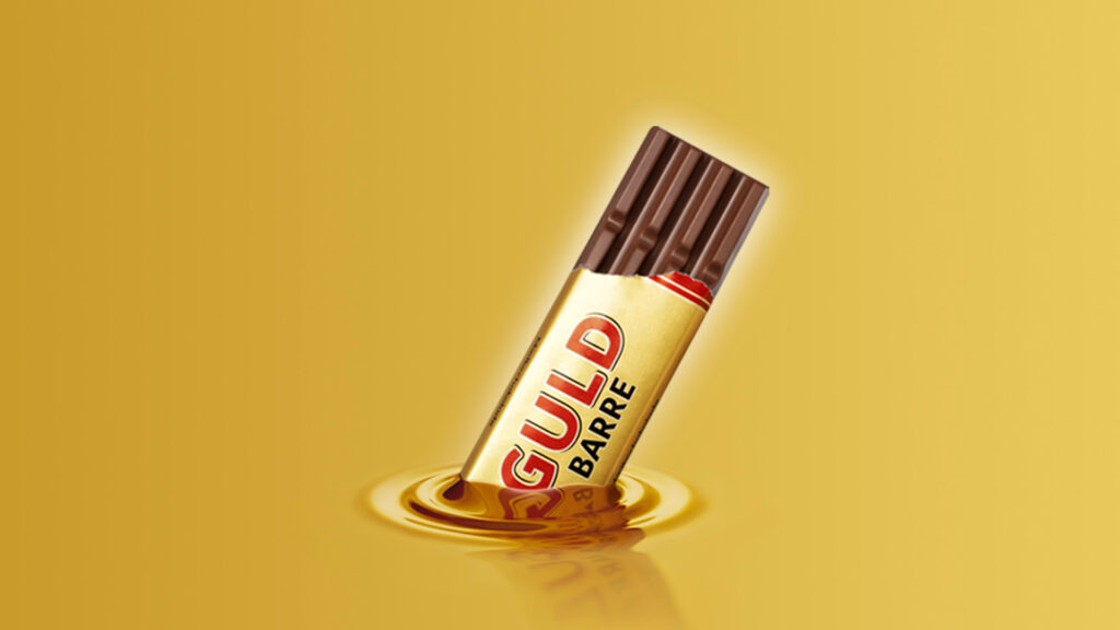 Toms Guldbarre halvt åben og halvt nedsunket i flydende guld på guldbaggrund